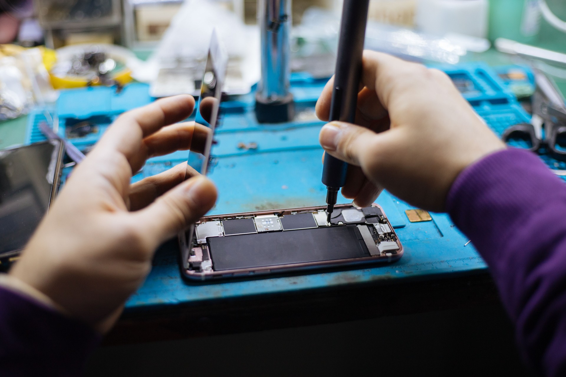 Technician repairing damaged smartphone