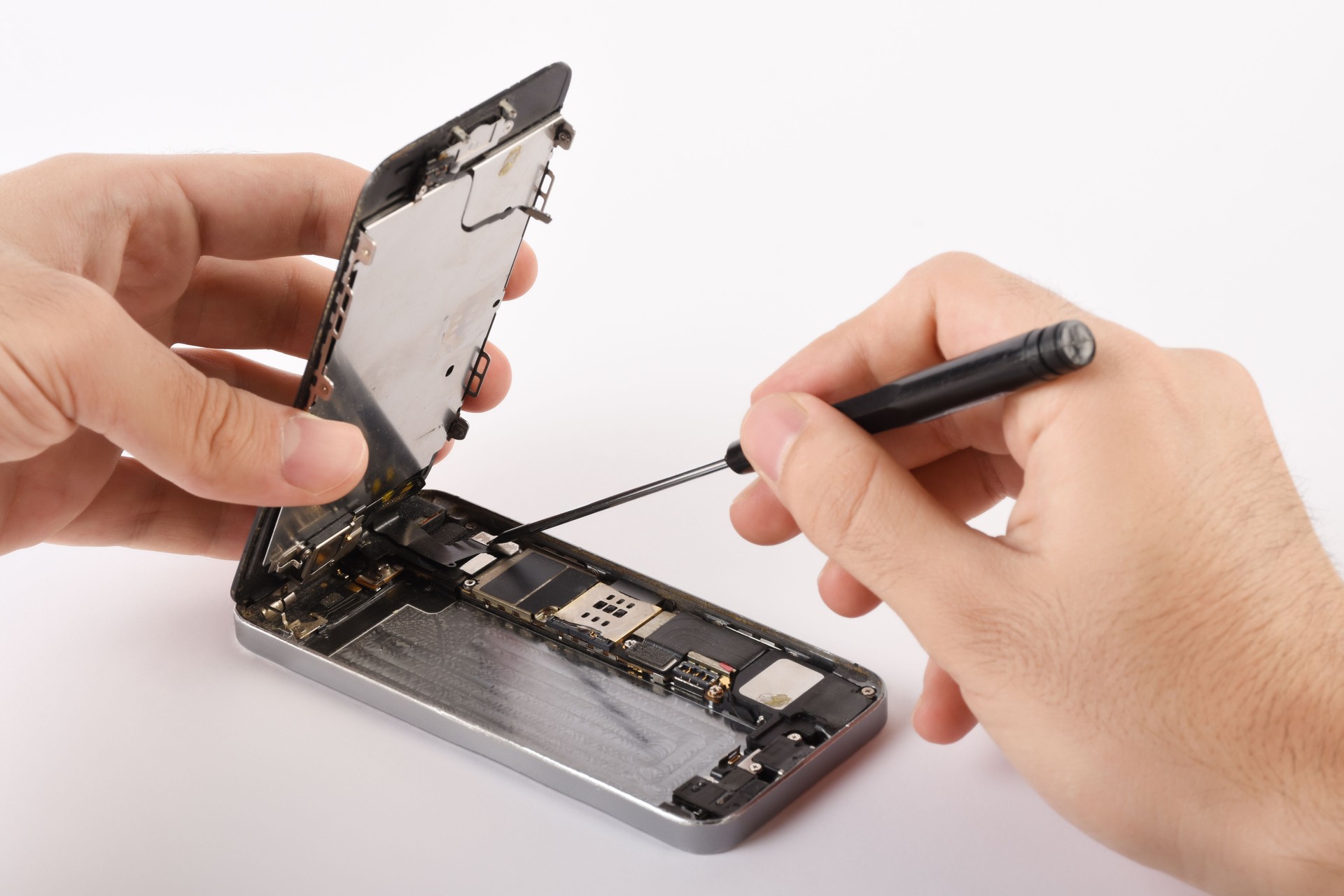 Technician repairs the damaged smart mobile phone, serviceman is repairing a damaged smart phone